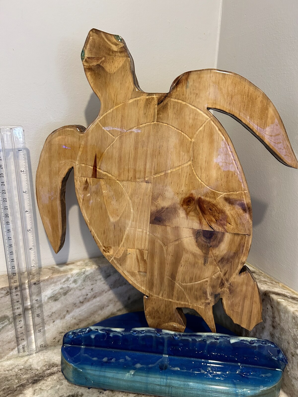 Hand-carved sea turtle sculpture with resin inlay and blue ocean base